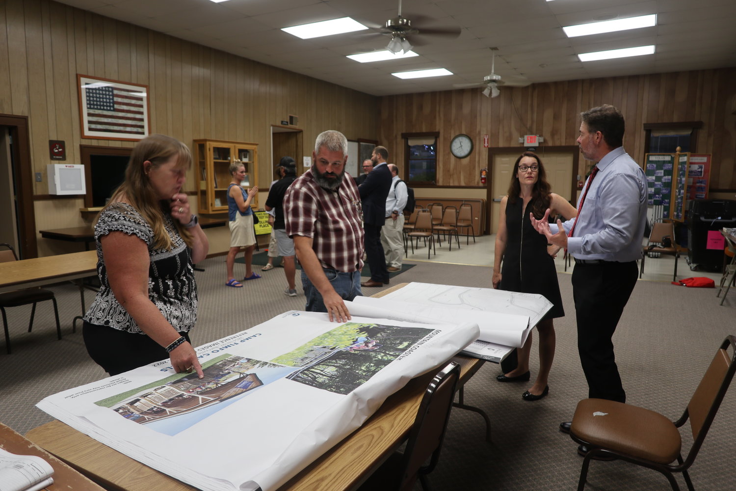 Jody Allen, left, of LaBella Associates, points out the different campsite facilities to Highland Planning Board chairman Norm Sutherland, as Caren LoButto of LaBella speaks with town engineer Ken Ellsworth.